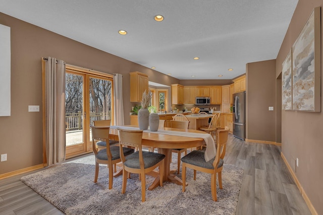 5061 Oxbow Pl, Champlin, MN 55316 - dining room with light wood-style flooring and recessed lighting