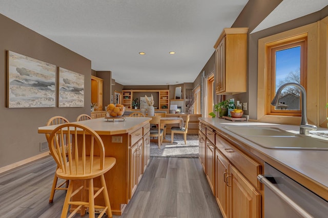 5061 Oxbow Pl, Champlin, MN 55316 - kitchen with dishwasher, dark wood finished floors, a kitchen island, a breakfast bar area, and recessed lighting
