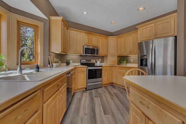 5061 Oxbow Pl, Champlin, MN 55316 - kitchen featuring appliances with stainless steel finishes, light brown cabinetry, recessed lighting, light countertops, and light wood finished floors