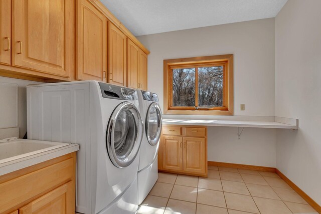 5061 Oxbow Pl, Champlin, MN 55316 - laundry area with cabinet space, separate washer and dryer, and light tile patterned floors