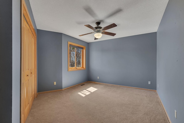 5061 Oxbow Pl, Champlin, MN 55316 - unfurnished bedroom with carpet flooring, a closet, ceiling fan, and a textured ceiling
