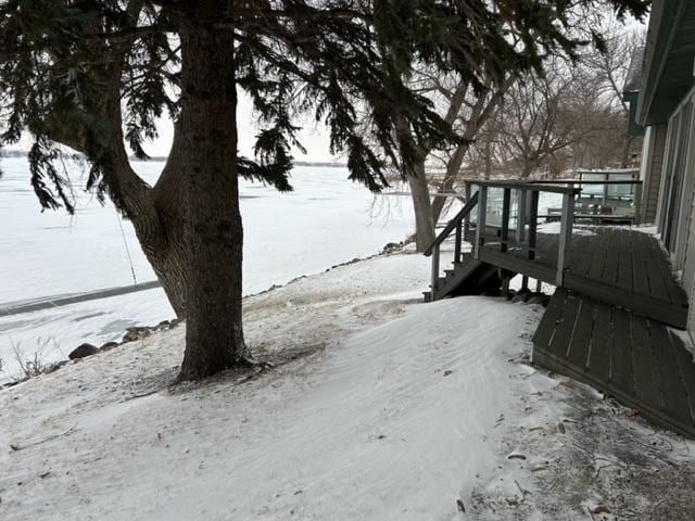 snowy yard featuring a wooden deck