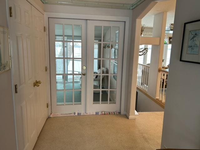 doorway to outside featuring carpet and french doors