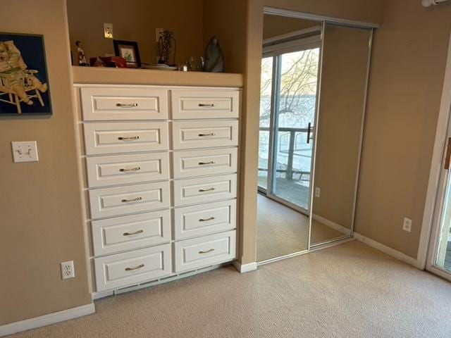 unfurnished bedroom featuring light colored carpet and access to outside