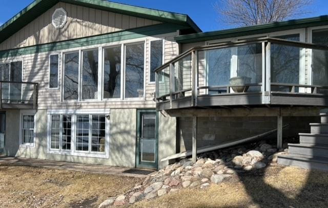 rear view of property with a sunroom