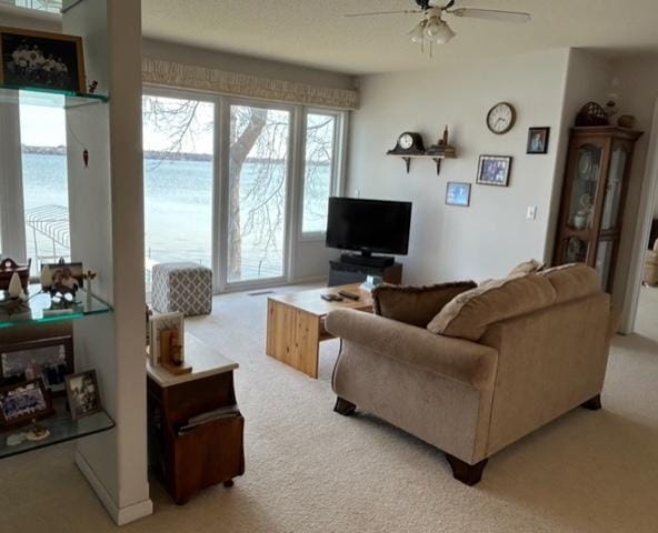 living room featuring light colored carpet and ceiling fan