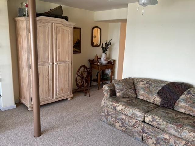 living room with light colored carpet and ceiling fan