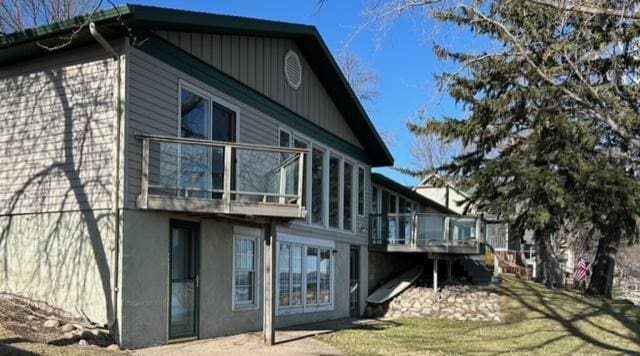 view of home's exterior with a wooden deck and stucco siding