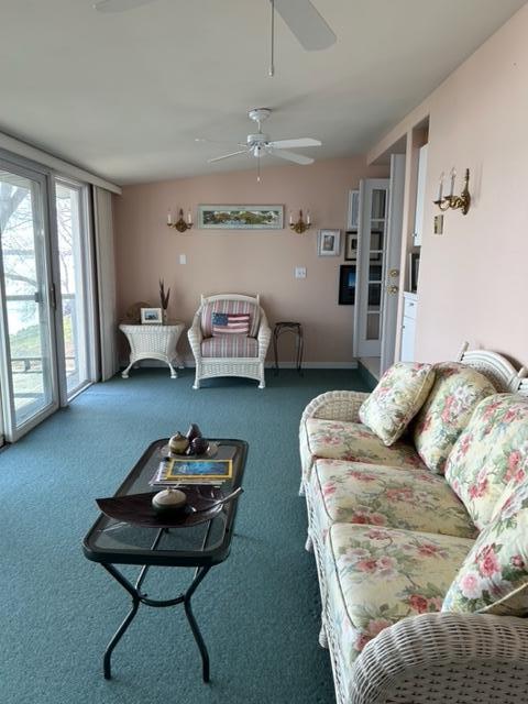 living room featuring ceiling fan and carpet floors