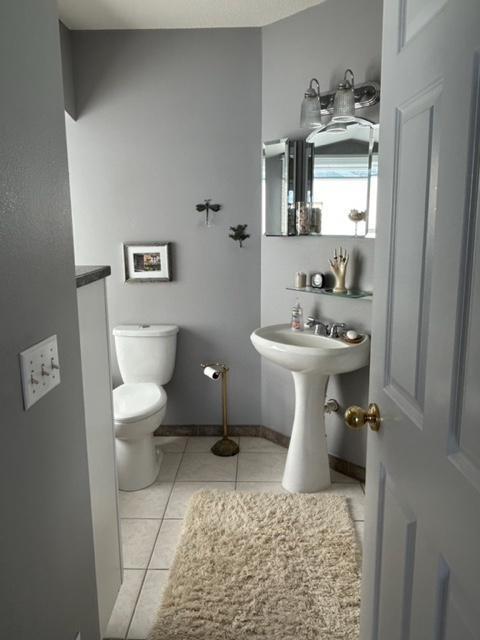 bathroom with toilet and tile patterned flooring