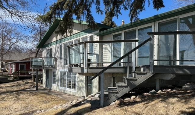 view of home's exterior with stairway and a deck