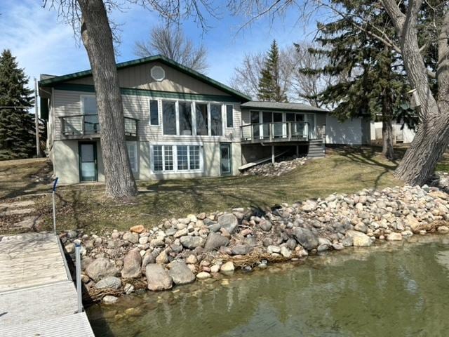 rear view of property with a water view