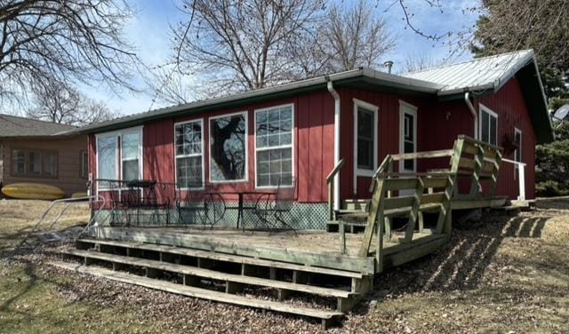 back of property featuring a wooden deck