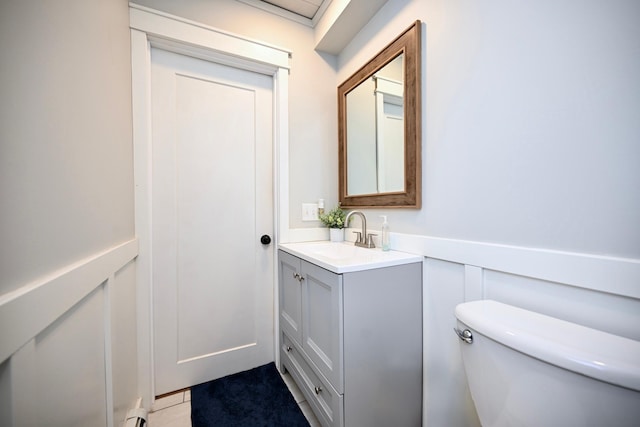 bathroom with tile patterned floors, vanity, and toilet