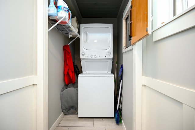 washroom featuring stacked washing maching and dryer