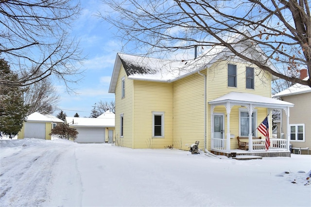 view of front facade with a porch, an outdoor structure, and a garage