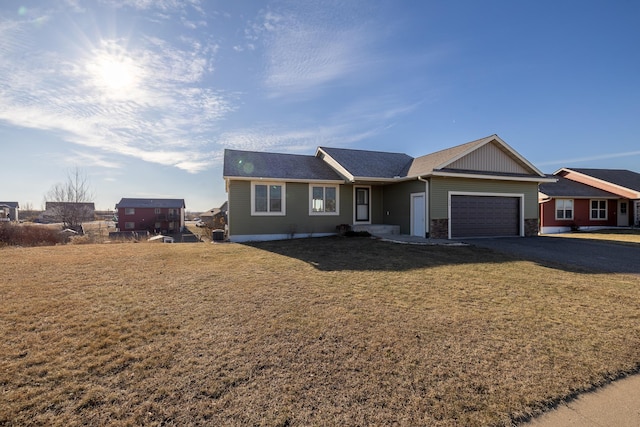 ranch-style house with a front yard and a garage