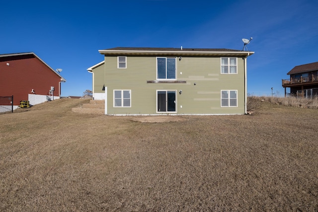 rear view of property with a yard