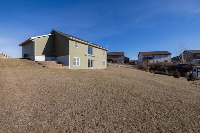 rear view of property with a yard