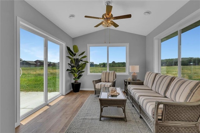 sunroom / solarium with ceiling fan and vaulted ceiling