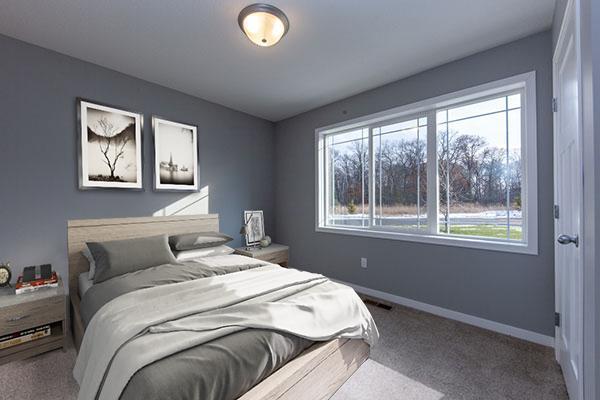 carpeted bedroom with multiple windows