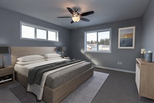 carpeted bedroom featuring multiple windows and ceiling fan