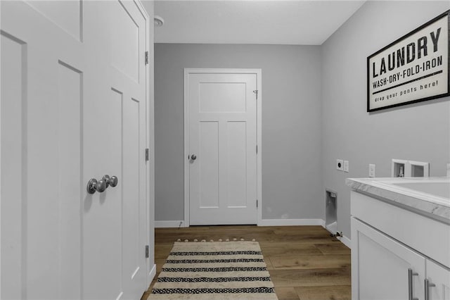 washroom featuring cabinets, hardwood / wood-style floors, electric dryer hookup, and washer hookup