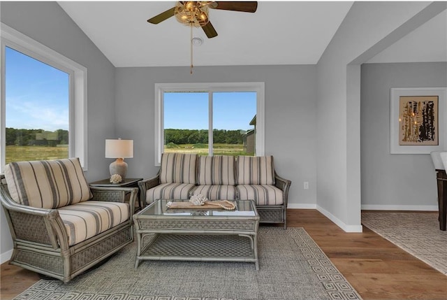 sitting room featuring hardwood / wood-style floors, ceiling fan, a wealth of natural light, and vaulted ceiling