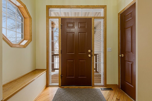 foyer entrance with a wealth of natural light and light wood-type flooring