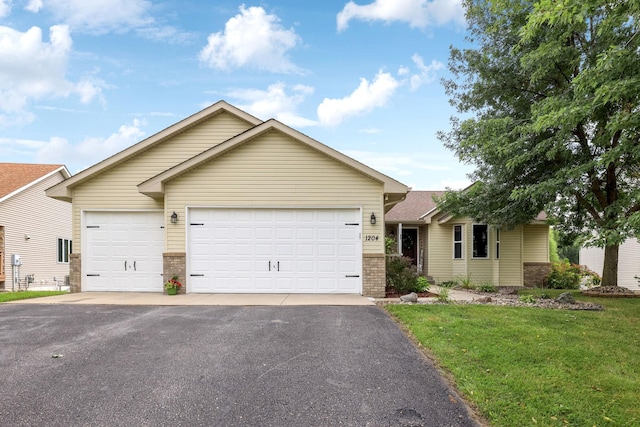 ranch-style house featuring a garage and a front lawn