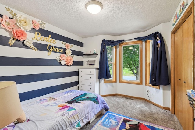 bedroom with carpet flooring, a textured ceiling, and a closet