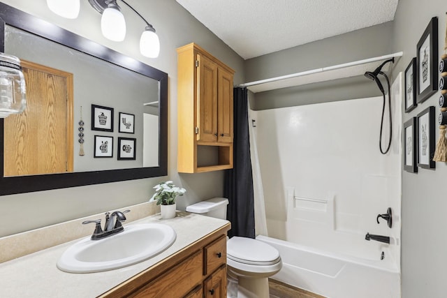 full bathroom with vanity, shower / tub combo, a textured ceiling, and toilet