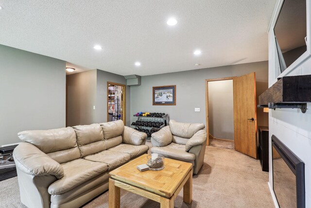 living room featuring a textured ceiling and light colored carpet