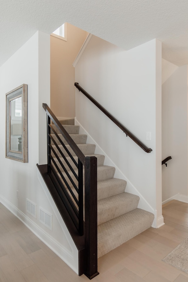 stairway with hardwood / wood-style flooring