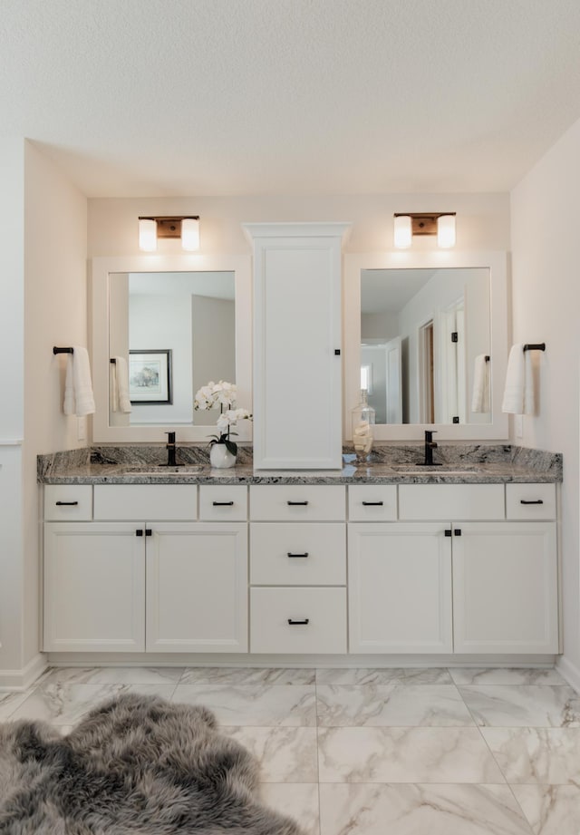 bathroom featuring a textured ceiling and vanity