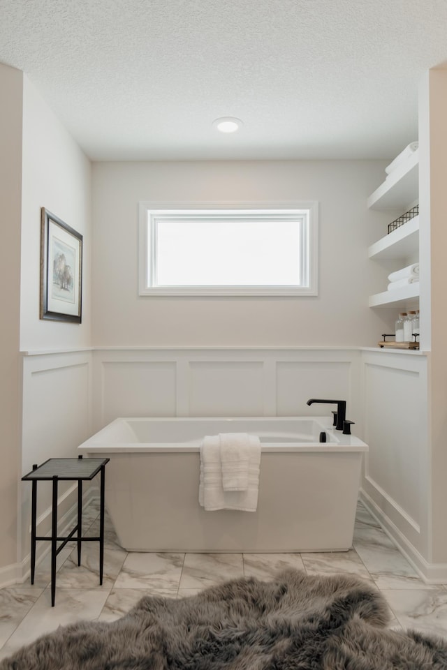 bathroom with a bathtub and a healthy amount of sunlight