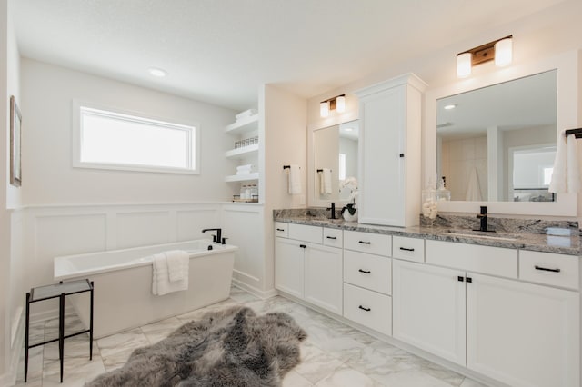 bathroom featuring a washtub and vanity