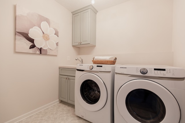 laundry room with cabinets, independent washer and dryer, and sink