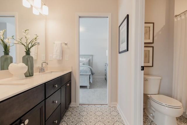 bathroom featuring tile patterned floors, vanity, and toilet