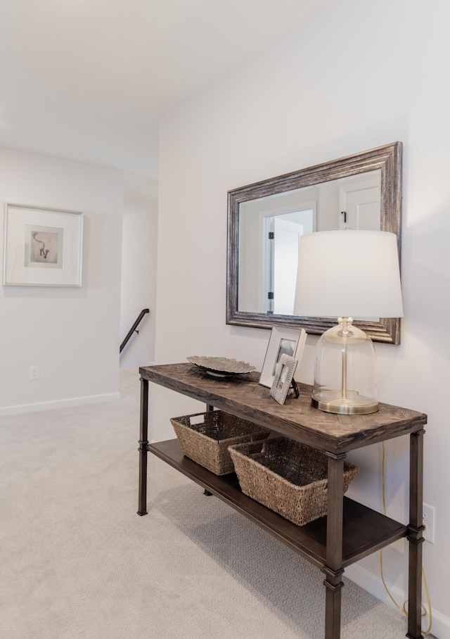 hallway with light colored carpet