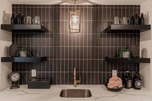 interior space featuring light stone countertops and sink