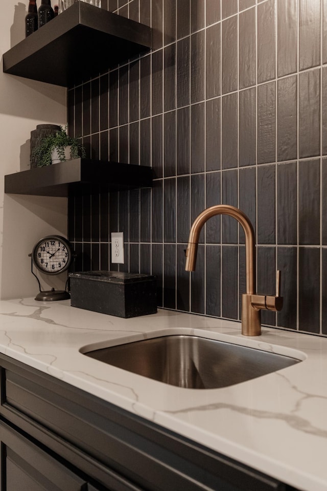 room details featuring sink and tasteful backsplash