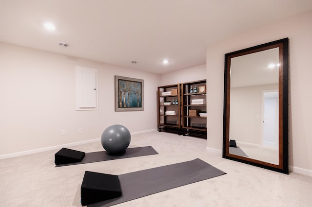 exercise room featuring light colored carpet