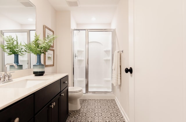 bathroom with tile patterned flooring, vanity, toilet, and a shower with door