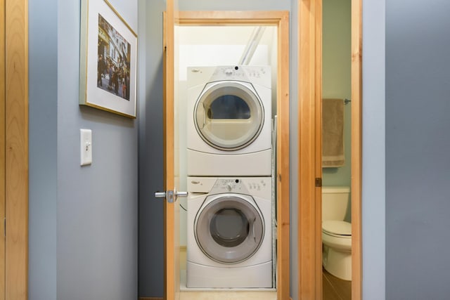 washroom featuring stacked washer / dryer