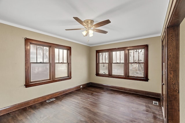 unfurnished room featuring ceiling fan, dark hardwood / wood-style flooring, and ornamental molding