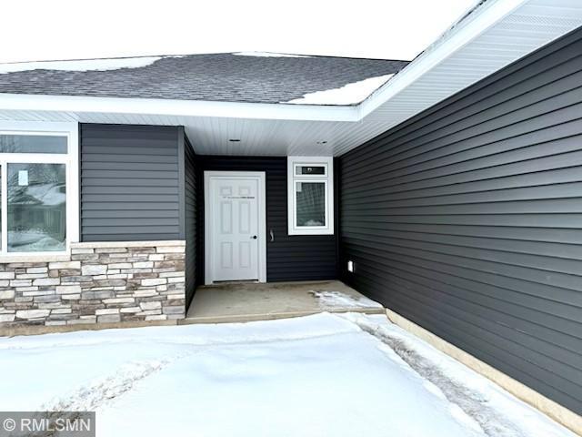 view of snow covered property entrance