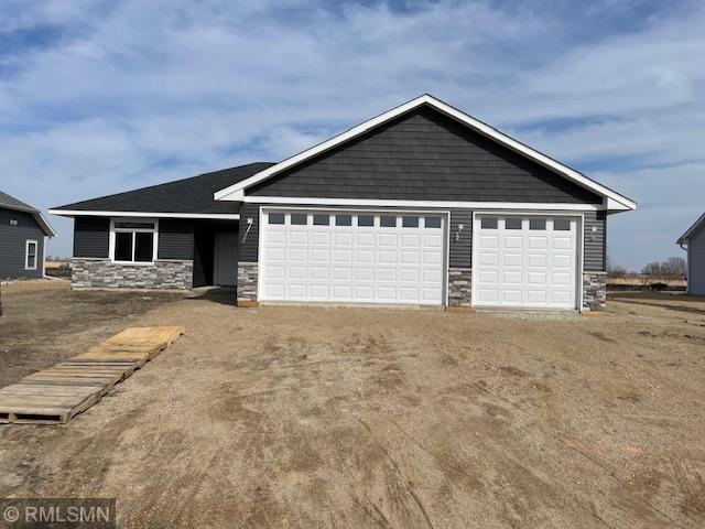 view of front of home featuring stone siding and driveway