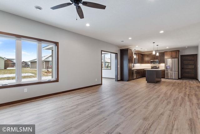 unfurnished living room with recessed lighting, ceiling fan, light wood-style floors, and baseboards