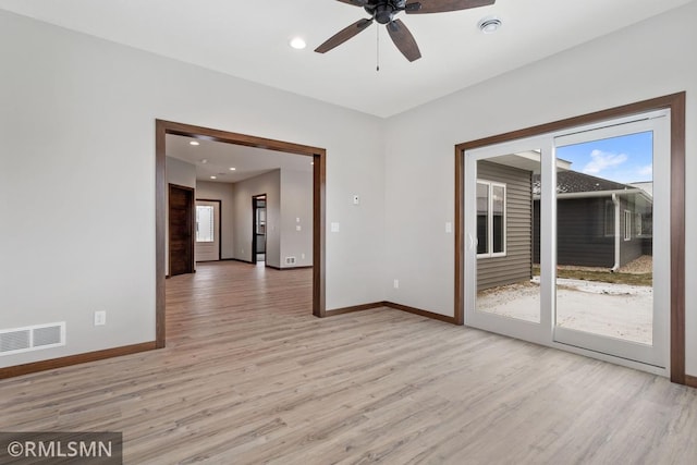 unfurnished room with visible vents, baseboards, ceiling fan, and light wood finished floors